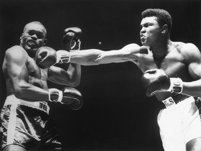 Great Boxer Muhammad Ali hitting a mighty punch on his opponent 