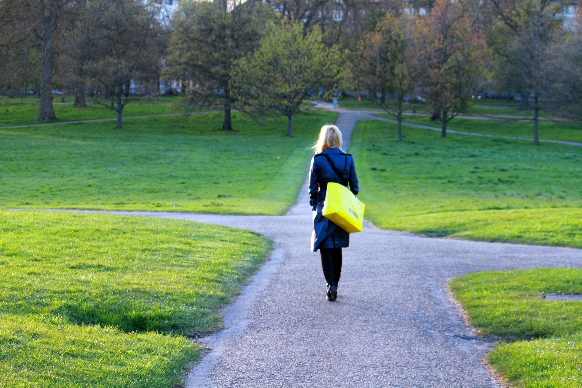 A young woman walking alone at the crossroad.