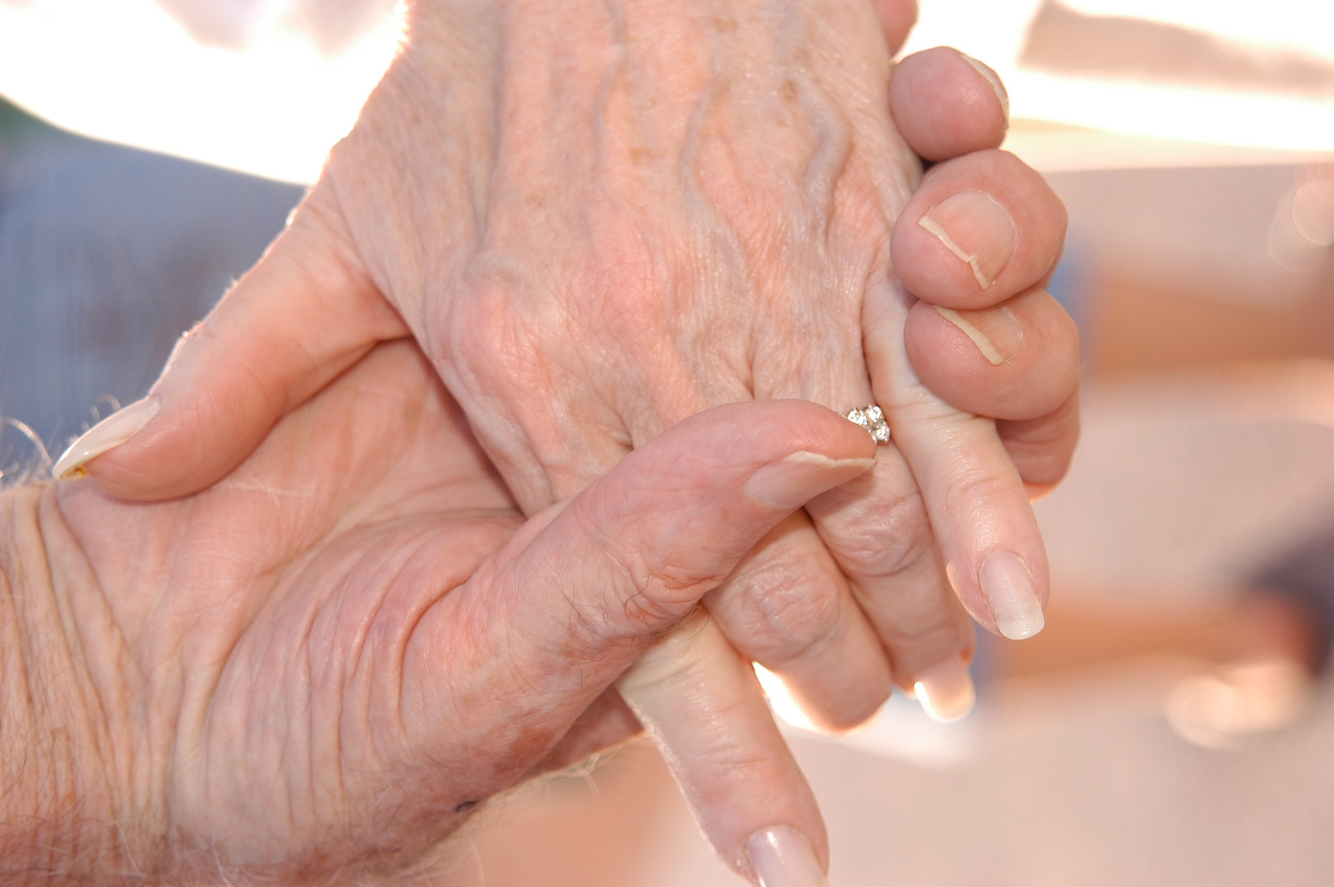 An elderly couple holding hands.